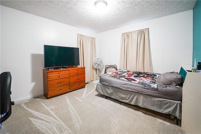 carpeted bedroom featuring a textured ceiling