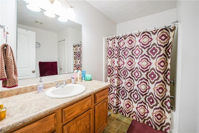 bathroom featuring vanity and walk in shower