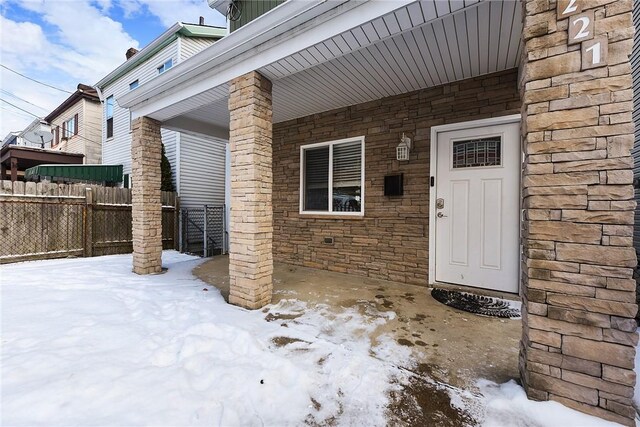 view of snow covered property entrance