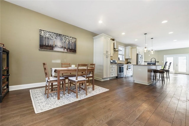 dining room featuring french doors, dark hardwood / wood-style flooring, and sink