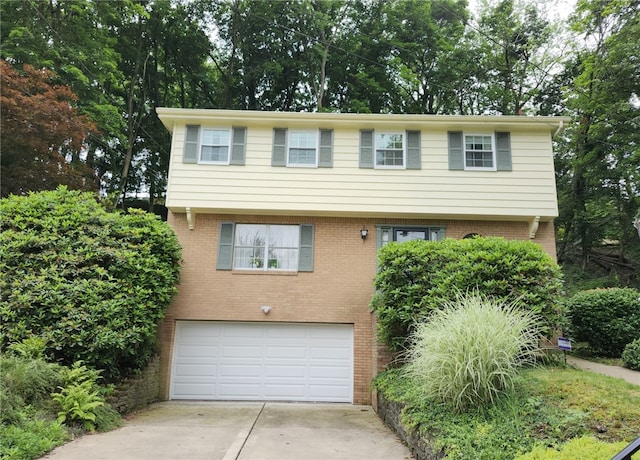 314 Surrey Pl, Churchill Boro, PA 15235 - colonial-style house with an attached garage, concrete driveway, and brick siding