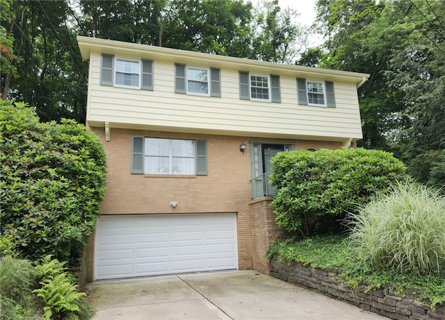 314 Surrey Pl, Churchill Boro, PA 15235 - view of front of home featuring an attached garage, brick siding, driveway, and view of scattered trees