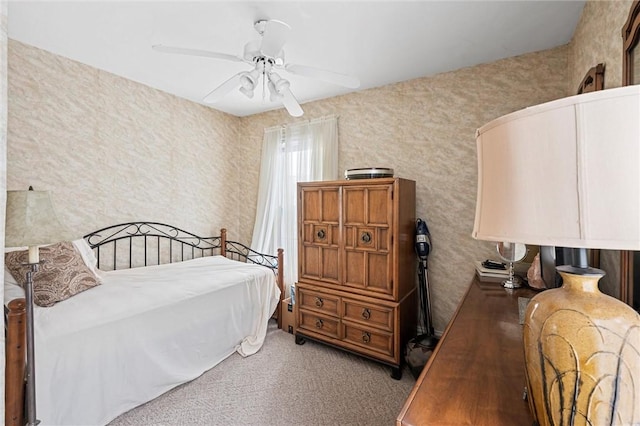 bedroom featuring light colored carpet and ceiling fan