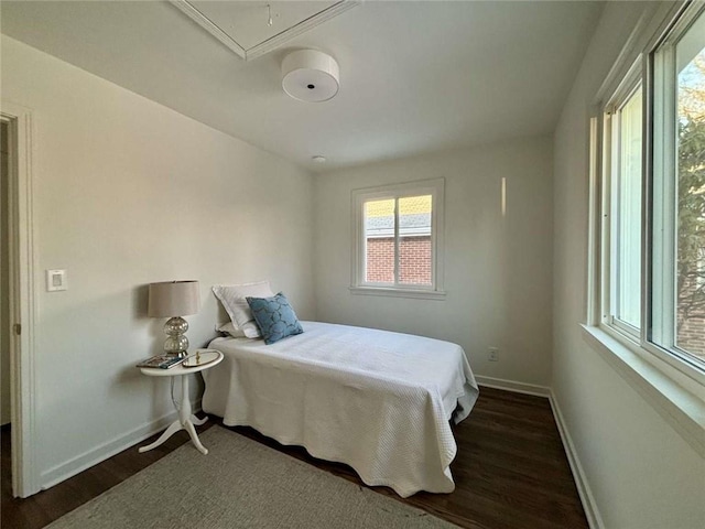 bedroom with dark wood-type flooring and multiple windows