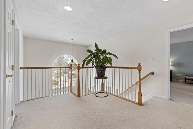 hallway featuring light colored carpet