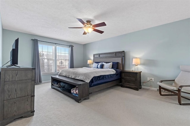 carpeted bedroom featuring a textured ceiling and ceiling fan