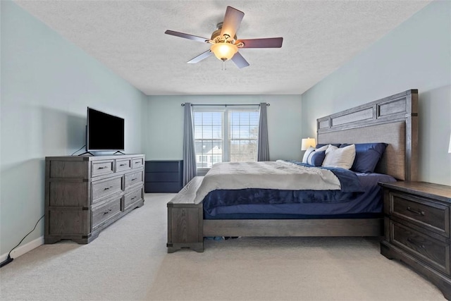 carpeted bedroom with a textured ceiling and ceiling fan