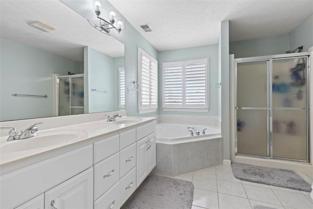 bathroom featuring vanity, tile patterned floors, a textured ceiling, and separate shower and tub