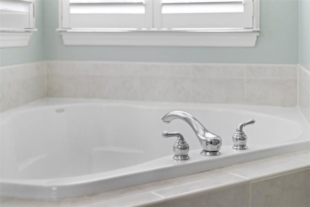 bathroom featuring a relaxing tiled tub