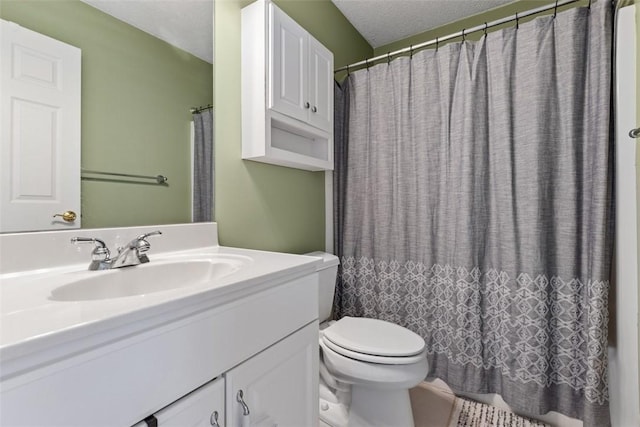 bathroom with vanity, a textured ceiling, and toilet