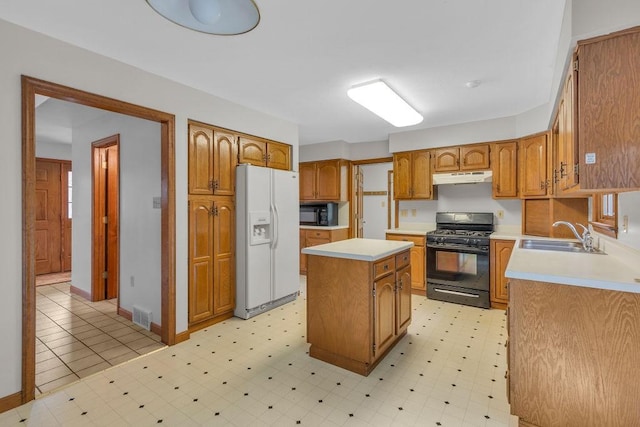 kitchen featuring a kitchen island, sink, and black appliances