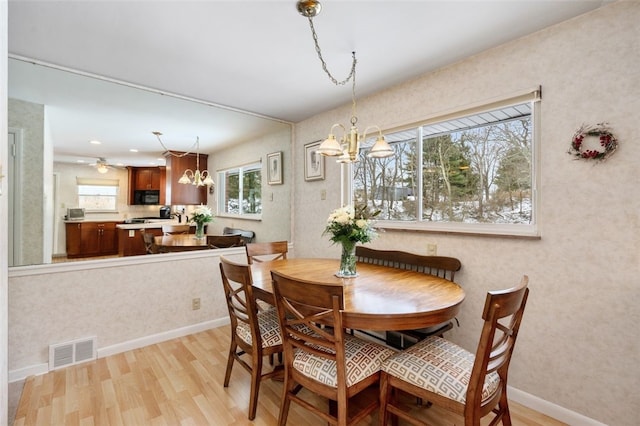 dining area featuring a chandelier and light hardwood / wood-style floors