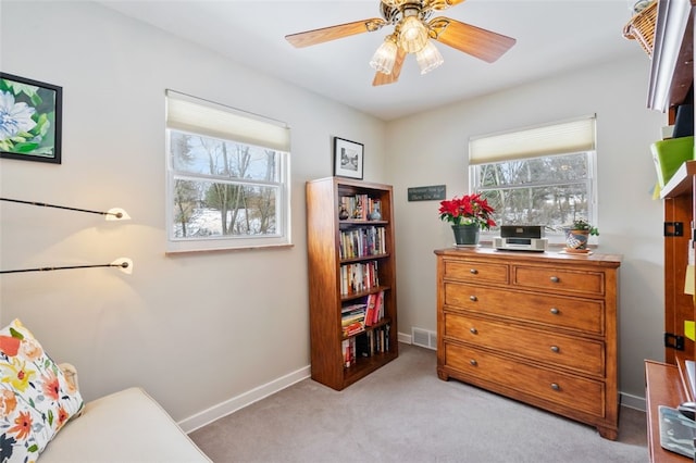 sitting room featuring plenty of natural light, light carpet, and ceiling fan