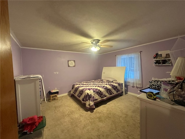 bedroom featuring crown molding, light colored carpet, and ceiling fan