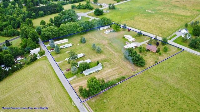 birds eye view of property with a rural view