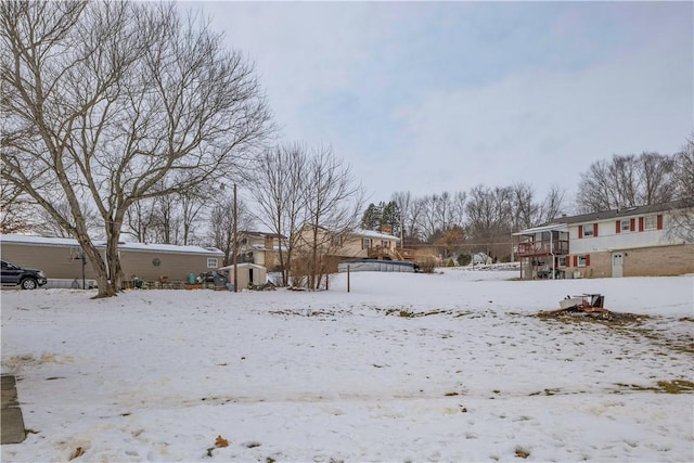 view of yard layered in snow