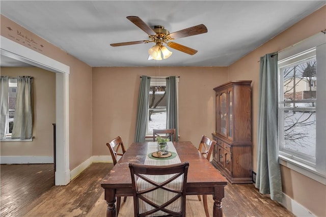 dining area featuring dark hardwood / wood-style flooring and ceiling fan