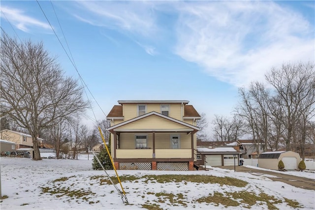 view of front of home with a garage, an outdoor structure, and covered porch