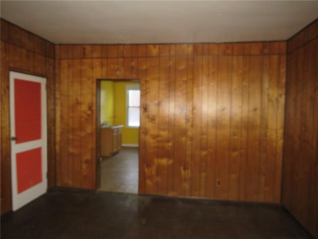 spare room with wood walls