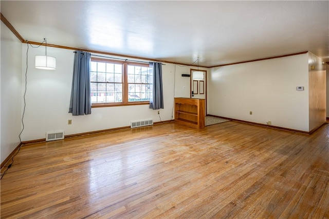 unfurnished room featuring crown molding and light hardwood / wood-style floors