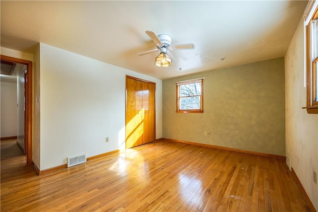 unfurnished bedroom with ceiling fan and light hardwood / wood-style floors