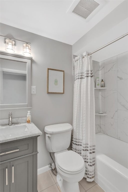 full bathroom with tile patterned flooring, vanity, toilet, and shower / bath combo with shower curtain