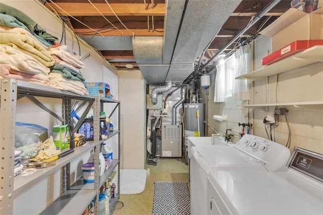 laundry room with water heater, sink, heating unit, and independent washer and dryer