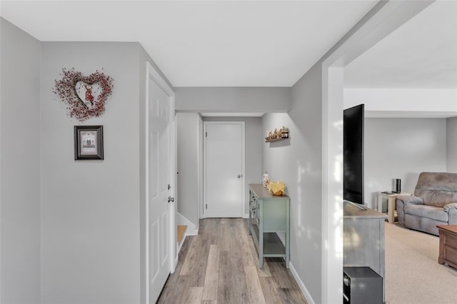 corridor with light hardwood / wood-style flooring