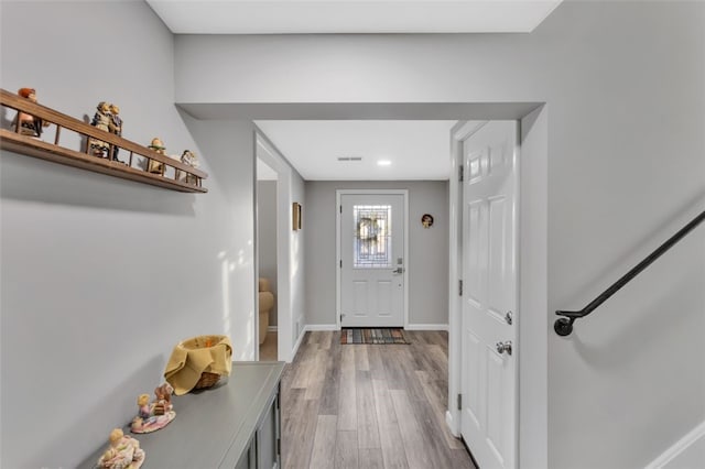 doorway to outside with wood-type flooring