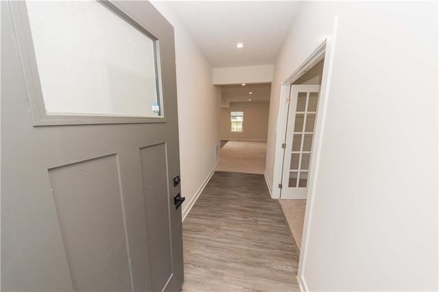 corridor with light wood-type flooring