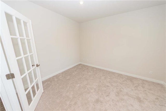 spare room with light colored carpet