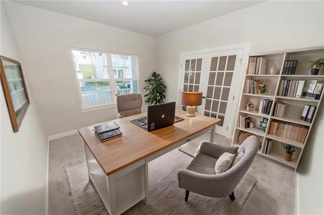 carpeted office with french doors