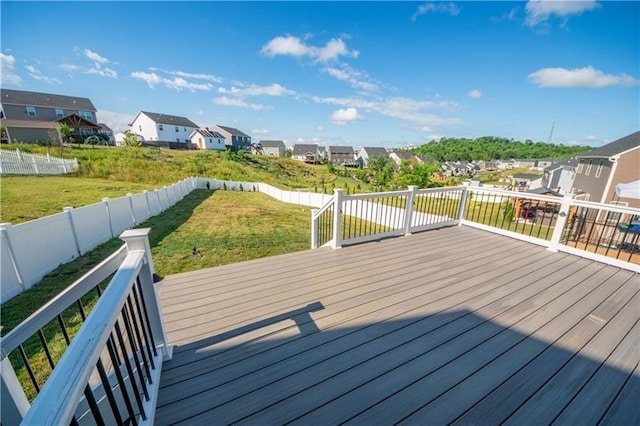 wooden terrace featuring a lawn