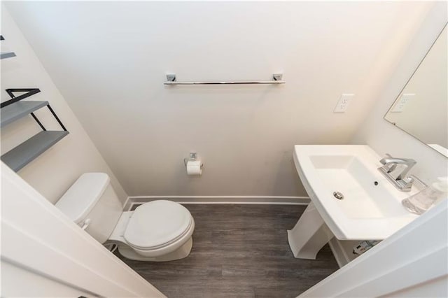 bathroom with wood-type flooring, sink, and toilet