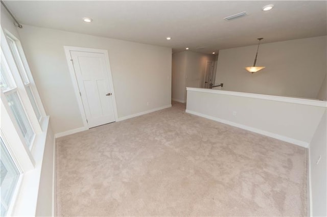 unfurnished room with light carpet