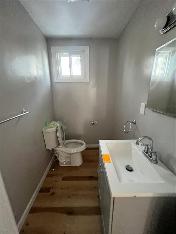 bathroom featuring hardwood / wood-style flooring, vanity, and toilet