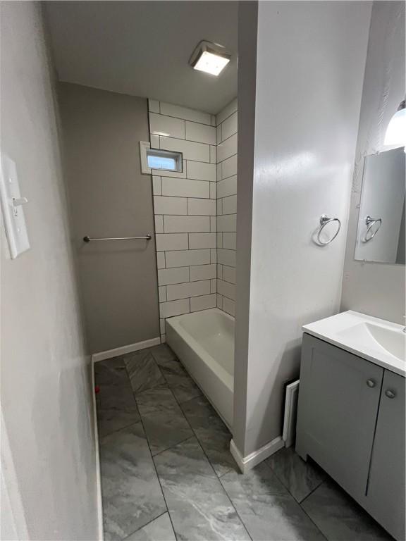 bathroom with vanity and a tile shower