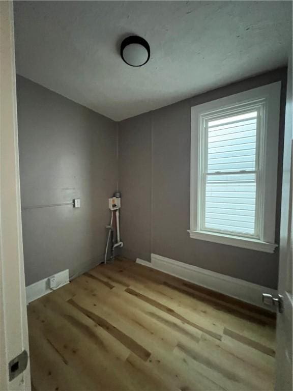 laundry room with light hardwood / wood-style floors