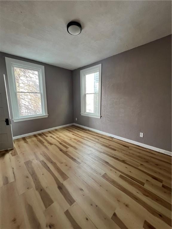 unfurnished room with light hardwood / wood-style floors