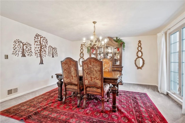 carpeted dining space with a notable chandelier