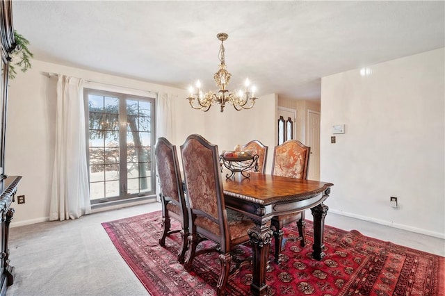 carpeted dining room featuring a chandelier