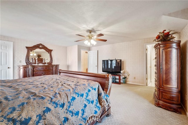 carpeted bedroom featuring ceiling fan and ensuite bathroom