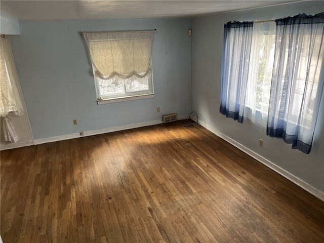 empty room featuring dark wood-type flooring