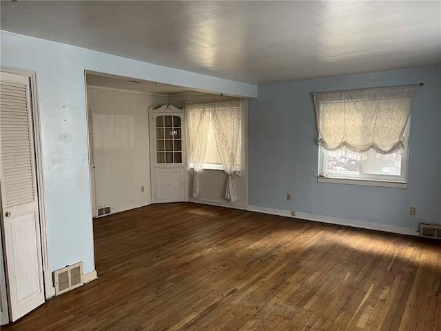 empty room featuring dark wood-type flooring