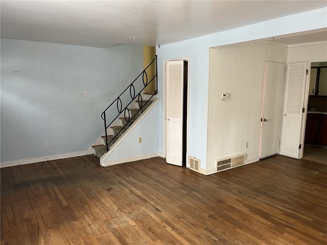 unfurnished room with dark wood-type flooring