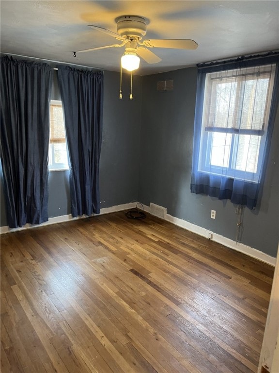 unfurnished room featuring ceiling fan and hardwood / wood-style floors