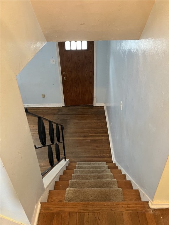 stairs with wood-type flooring