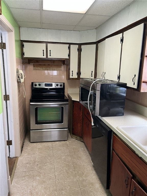 kitchen featuring a drop ceiling and stainless steel appliances