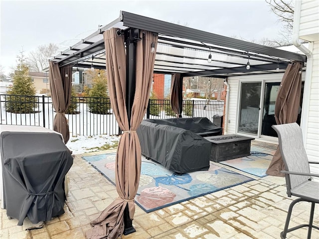 view of patio with a fire pit, area for grilling, and a pergola