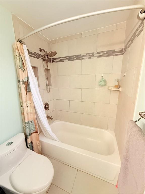 bathroom featuring tile patterned flooring, toilet, and shower / bath combo with shower curtain